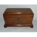 A regency mahogany sarcophagus shaped tea caddy with ring handles and fitted interior