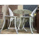 A Victorian style cast aluminium garden terrace table with decorative pierced circular top raised on