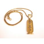 An unmarked yellow metal Egyptian gold plaque pendant with gold rope link chain, 10g approx