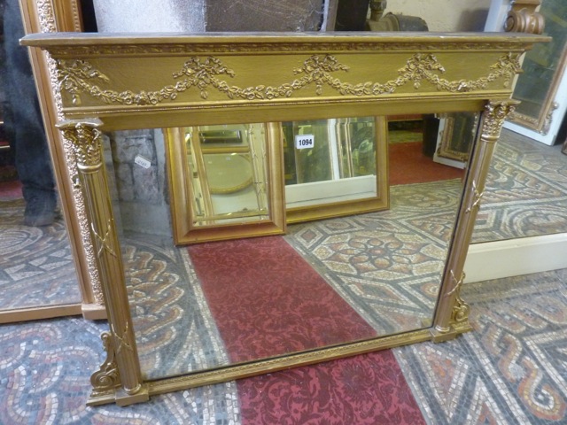 A small Regency style over mantle mirror of rectangular form with bevelled edge plate set within a