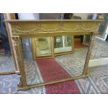 A small Regency style over mantle mirror of rectangular form with bevelled edge plate set within a