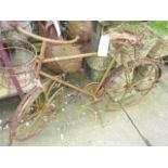 A weathered novelty card planter in the form of a bicycle together with two further novelty garden