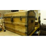 A Victorian pine, lathe and steel banded domed topped travelling trunk/chest with side carrying