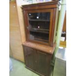 An Edwardian mahogany side cupboard enclosed by two panelled doors, the upper section recessed and