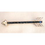 An Art Deco 14k gold sapphire and diamond arrow brooch with channel set sapphire shaft and free