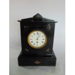 A Victorian polished slate mantle clock, the casework of classical form with enamelled dial, also
