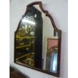 A small Georgian style wall mirror, the walnut frame with stepped and arched outline with gilt