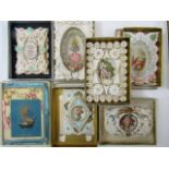 A box containing a quantity of Victorian highly decorative relief and cut paper cards including