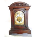 An Edwardian period mantle clock, the case enclosing an arched brass dial with silvered chapter