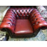 A Chesterfield armchair in oxblood red leather with buttoned finish