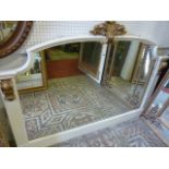 An over mantle mirror, the painted frame with moulded outline and applied gilt wood corbels and