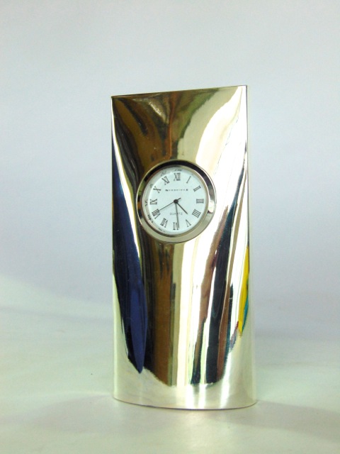 A silver plated mantle clock with quartz movement