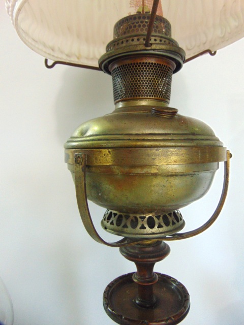 an Edwardian oil lamp raised on a turned walnut base and column, together with two further lamps - Image 2 of 2