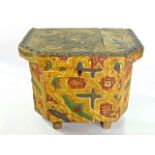 An unusual rustic box and cover with canted corners, carved and naively painted detail, 32cm wide