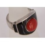 A red coral and onyx Art Deco ring with indistinct marks in unmarked white metal size I, 10g approx