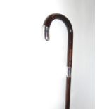 A walking cane with silver collar and tip dated London 1919