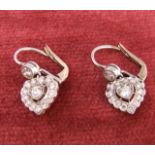 A pair of early 20th century platinum and diamond heart shaped drop earrings, approximately total