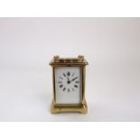 A simple brass eight day carriage clock with enamelled dial