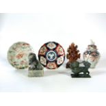 An Imari vase and cover with painted bird decoration, two Imari type dishes and three soapstone type