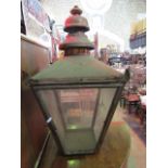 A Victorian copper framed street lantern of square tapered form with glazed panels and raised