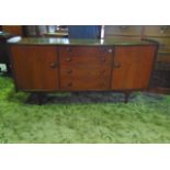 An A Younger Ltd afromosia side board, the top with bow fronted outline over a tower of four long