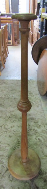 A mid height stripped oak lamp standard