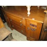 A reproduction oak shallow breakfront dressing table in the old English style, partially enclosed by