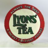 A vintage shop advertising sign, Lyons Tea, printed in a green and red colourway on a circular