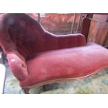 A Victorian chaise lounge with moulded supports on cabriole feet upholstered in coloured velvet with