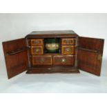 A Victorian smokers cabinet enclosed by two doors, the interior fitted with a ceramic jars and six