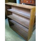 A light oak floor standing open bookcase with fixed shelves