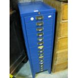 A floor standing blue painted steel pedestal paper filing cabinet fitted with fifteen index drawers