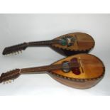 An eight string mandolin with marquetry detail, together with a further mandolin and case, the