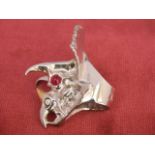 An 18ct white and yellow gold diamond and cabochon ruby dragon, ring size R by repute a gift from