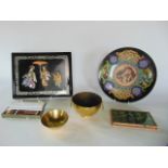 A Japanese lacquered panel, a cloisonné dish with writhing dragon and phoenix detail, brass bowls,