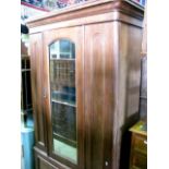 A Victorian mahogany single wardrobe with moulded cornice over a central three quarter length arched