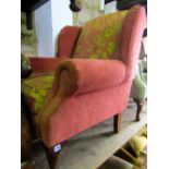A contemporary wing armchair with floral patterned upholstered finish and stained beechwood cabriole