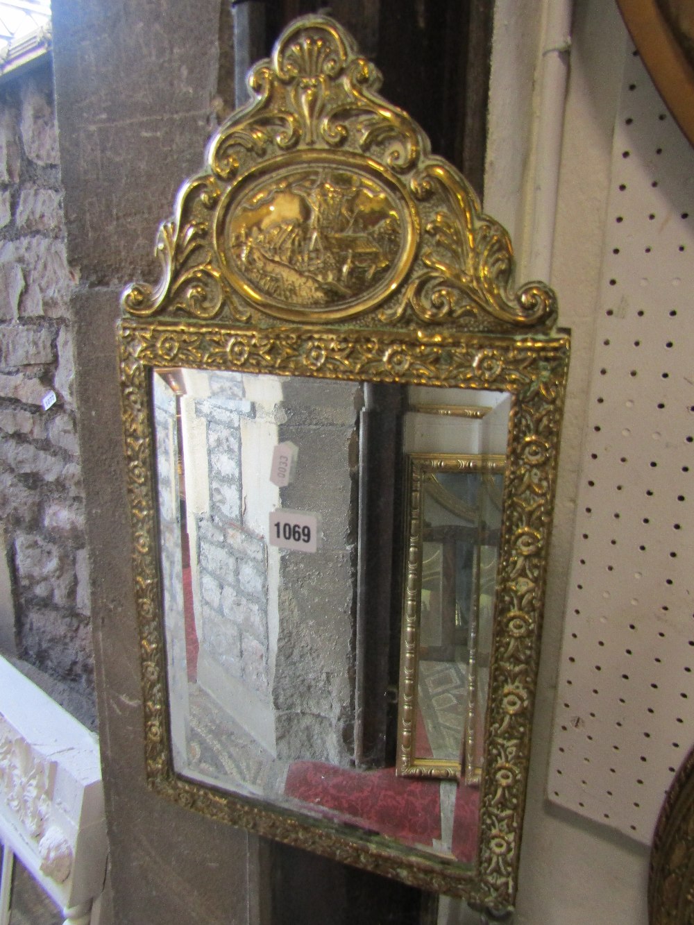 A small Dutch style wall mirror with bevelled edge rectangular plate, brass clad foliate surround