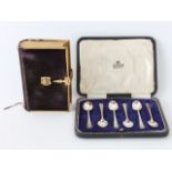 A cased set of Art Deco coffee spoons, Sheffield 1938, together with a book of common prayer, velvet