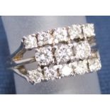 A multi-stone diamond ring set with thirteen round cut diamonds in unmarked white metal 1ct approx