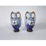 A pair of late 19th century continental two handled vases with painted and gilded floral