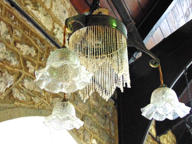 An art deco ceiling light with three branches and central light, with etched glass shade and glass