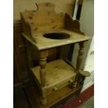 A Victorian style stripped pine washstand on two tiers, the upper with three quarter raised