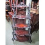 A Victorian mahogany five tier graduated whatnot with barley twist supports and finials