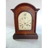 An Edwardian mahogany bracket clock, the arched and silver dial with silent chime selector, the