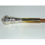A walking cane with embossed white metal tip