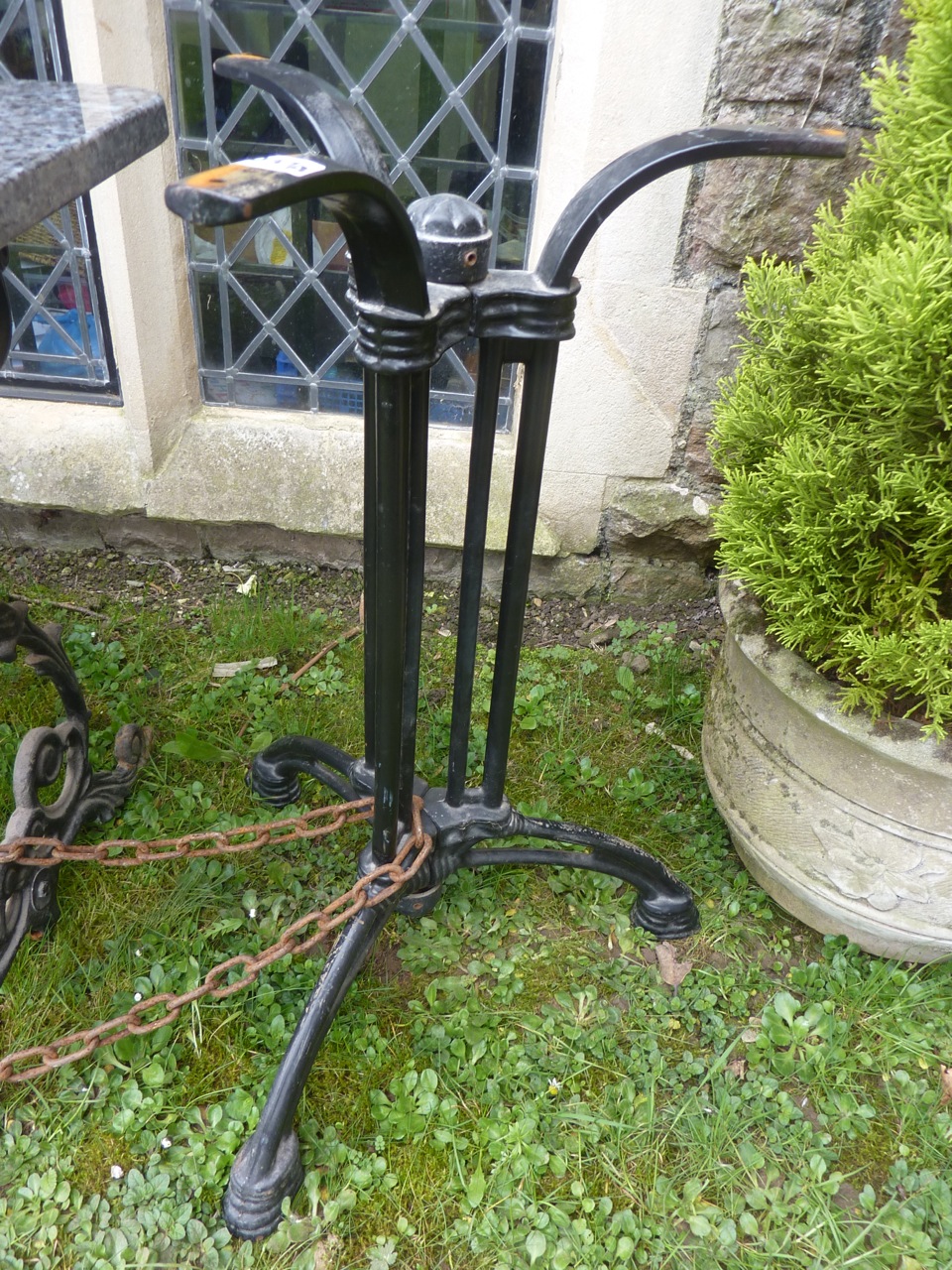 A reproduction cast iron garden or pub table base with shaped tripod supports