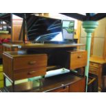 A G Plan teak dressing table with triple mirror back raised on a shallow bow fronted platform over