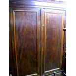 A 19th century mahogany armoire enclosed by a pair of three quarter length rectangular moulded