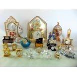 A collection of highly decorative modern mantle clocks in various cases mainly ceramic and a further